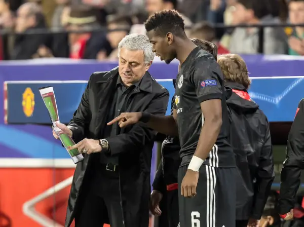 Jose Mourinho showing Paul Pogba a coaching playbook